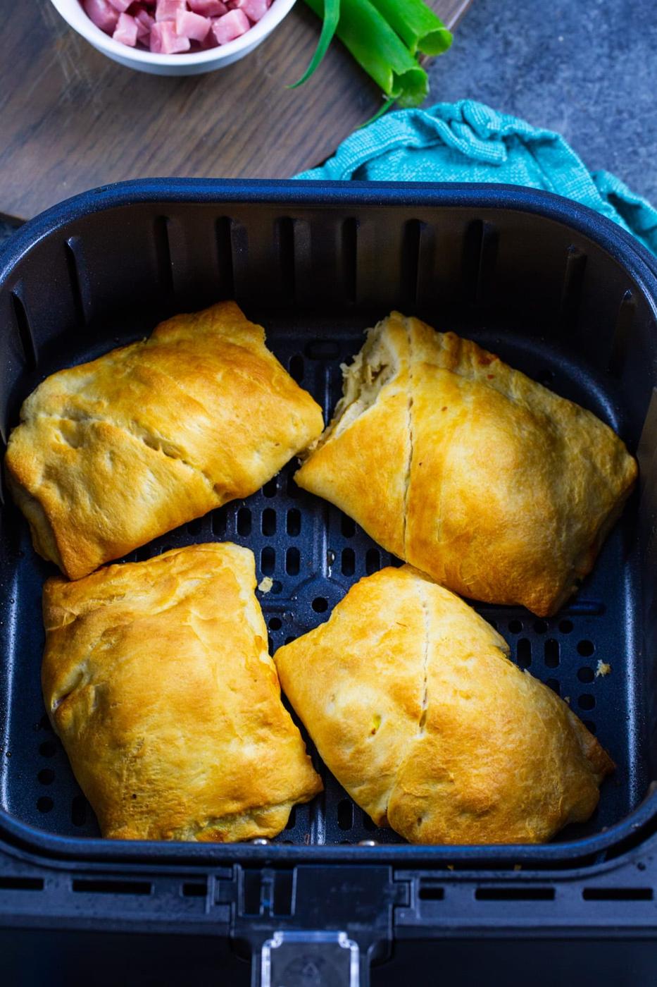 Ham and Egg Pockets in air fryer basket.