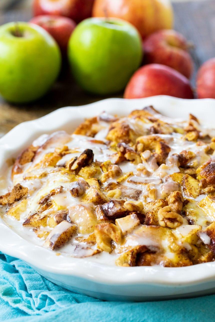 Cinnamon Roll Bake with apples in background.