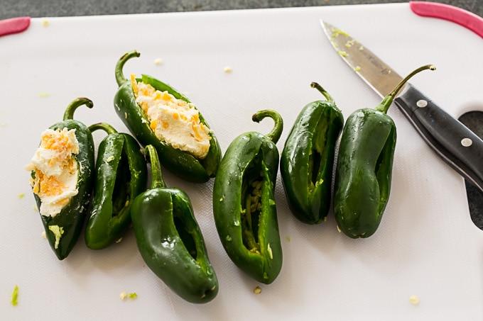 Stuff the jalapenos with cream cheese