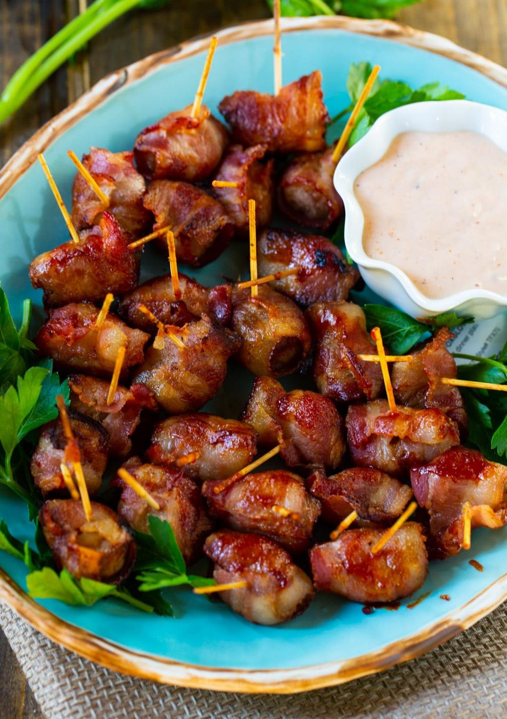 Bacon-Wrapped Water Chestnuts on serving platter with dip.