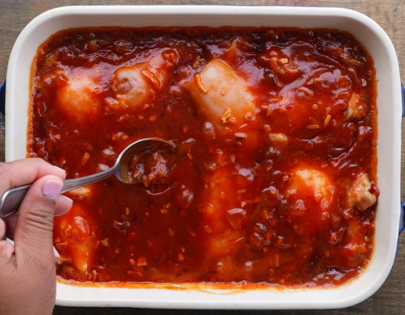 Spooning glaze over chicken.