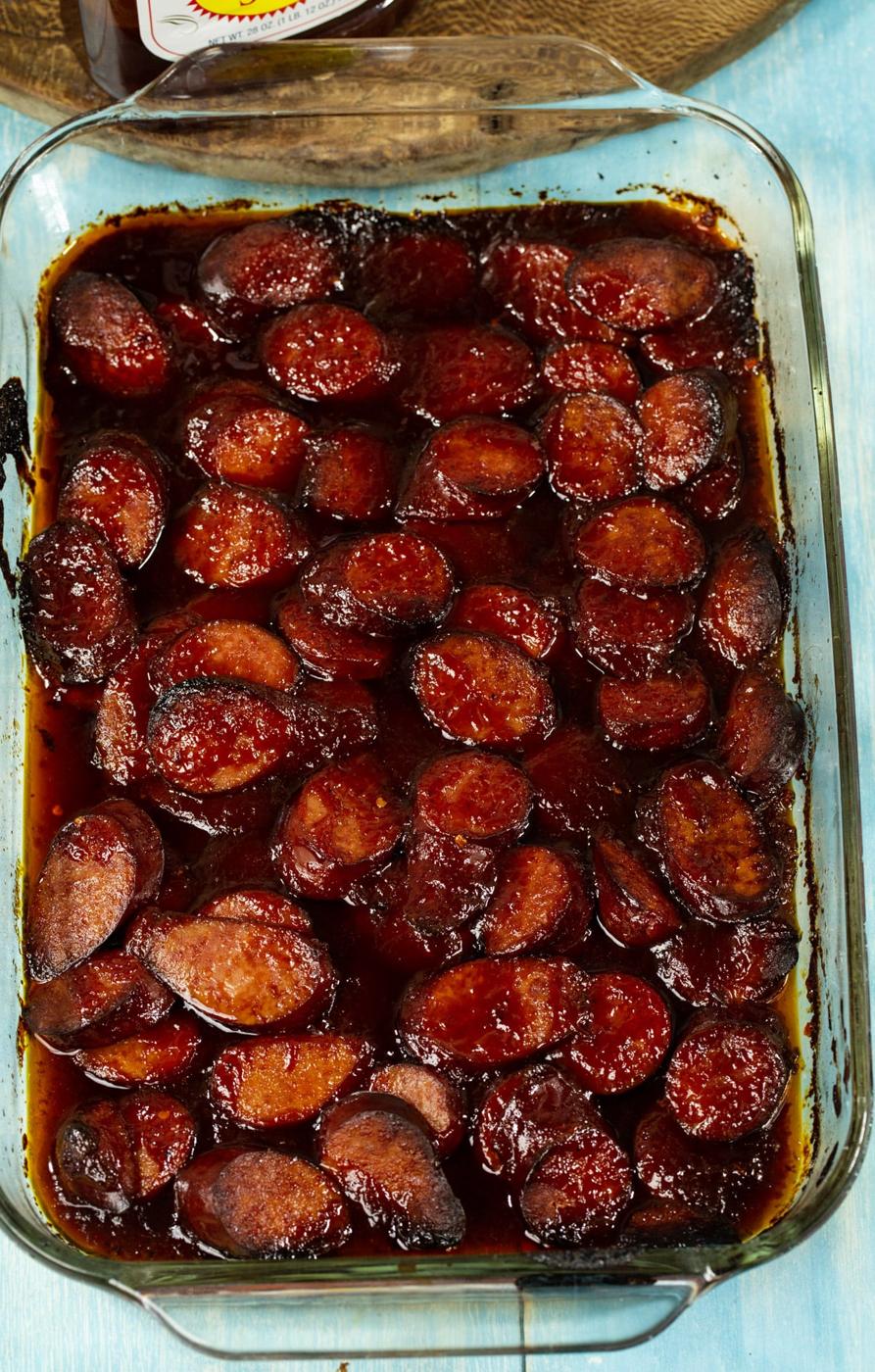 Cooked sausage slices in baking pan.