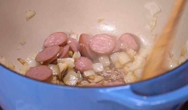 Cooking the sausage and garlic.