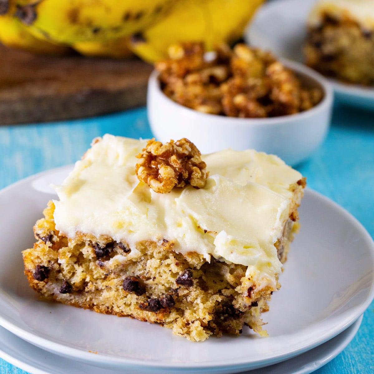 Banana Cake with Cream Cheese Frosting on a small plate.