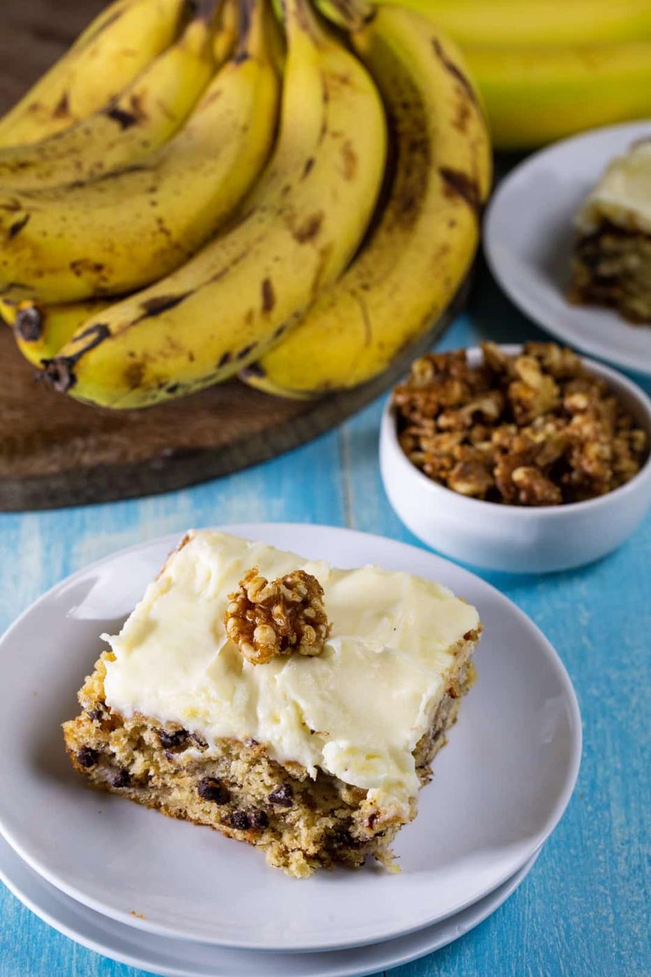 Banana Cake with Cream Cheese Frosting slice on a plate.