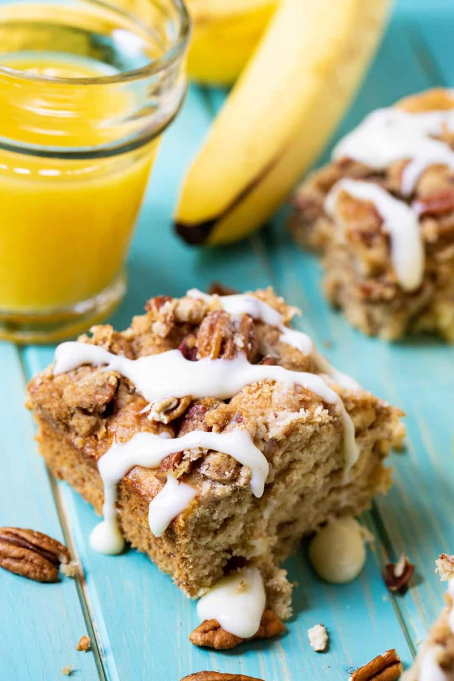 Piece of coffee cake with glass of orange juice.