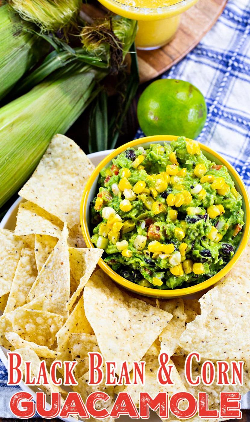 Black Bean and Corn Guacamole in a bowl surrounded by chips.