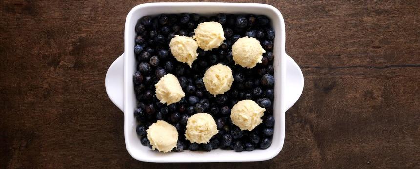 Dough place on top of blueberries.