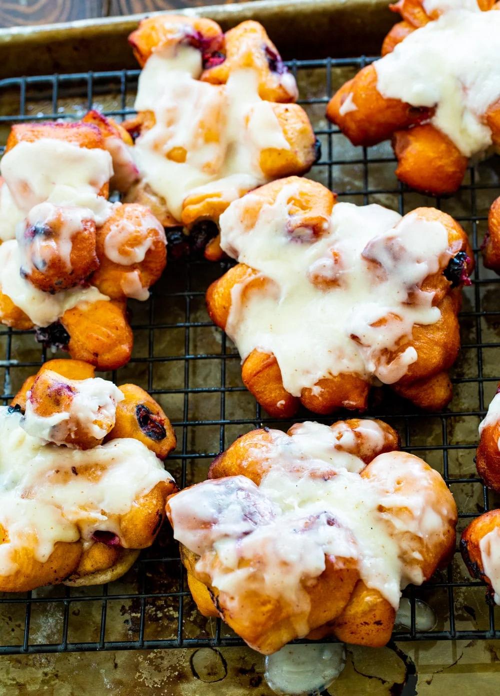 Blueberry Fritters with Browned Butter Glaze on a rack.
