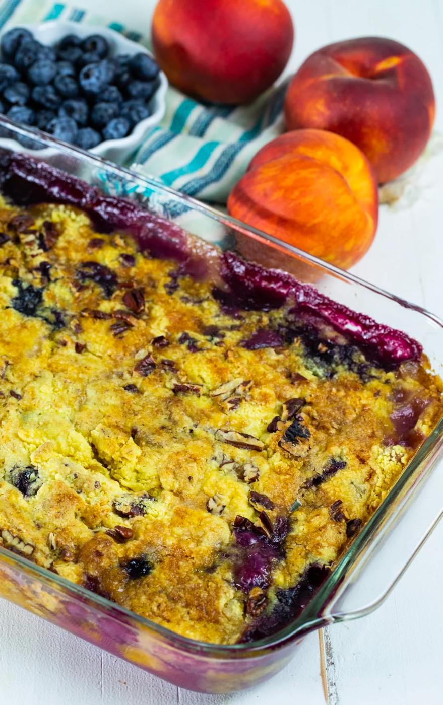 Dump Cake in baking dish and bowl full of blueberries.