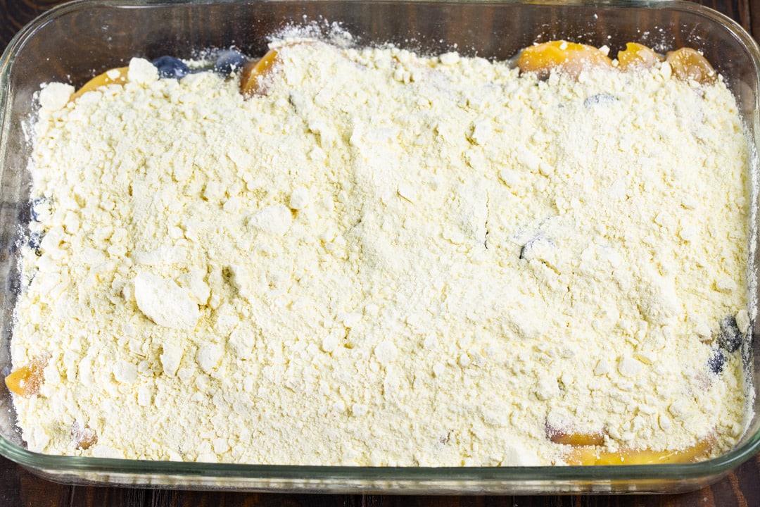 Dry cake mix sprinkled over blueberries and peaches.