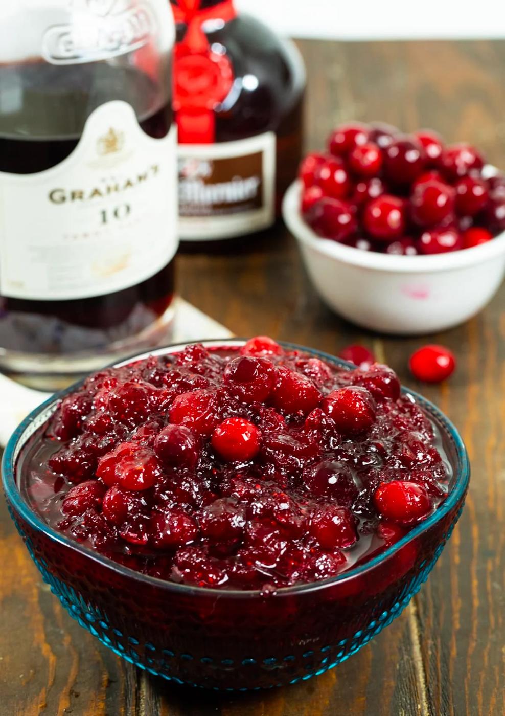 Cranberry sauce in a bowl and bowl of fresh cranberries.
