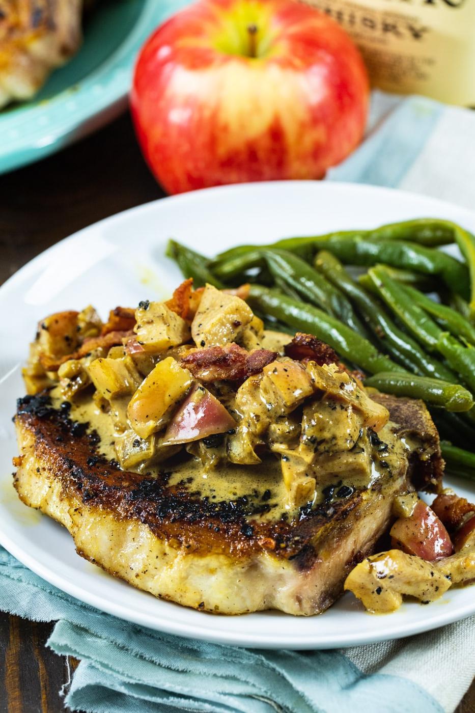 Close-up of cooked pork chop on a plate.