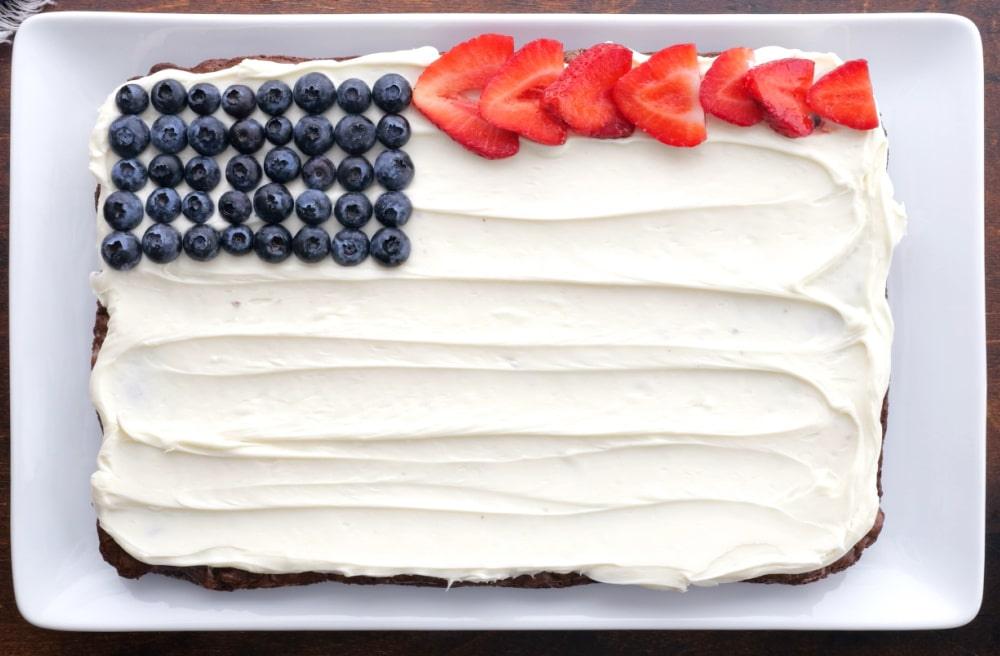 Arranging fruit on brownie.