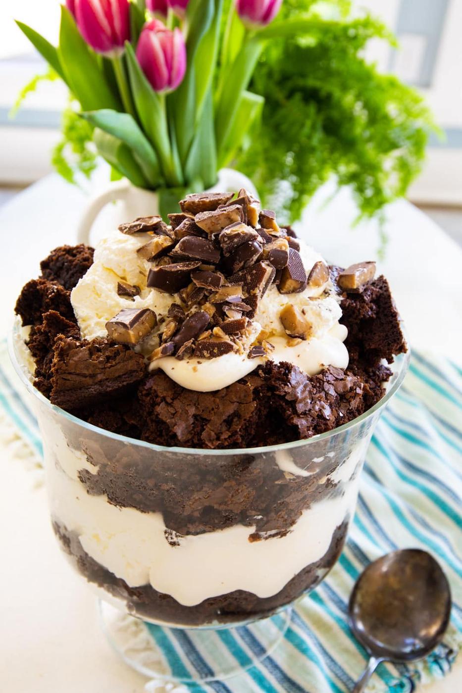 Brownie Trifle in a trifle bowl and tulips in background.