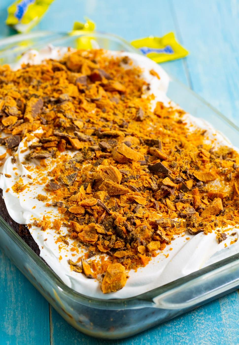 Whole Butterfinger Poke Cake in 9x13-inch baking dish.
