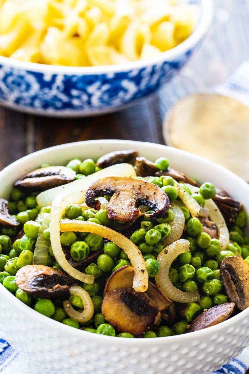 Buttered Peas with Mushrooms in a white bowl.