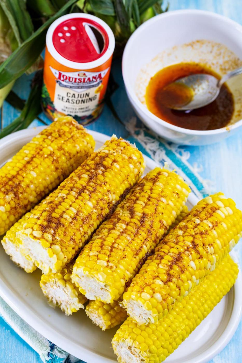 Corn on the cob covered with cajun butter.