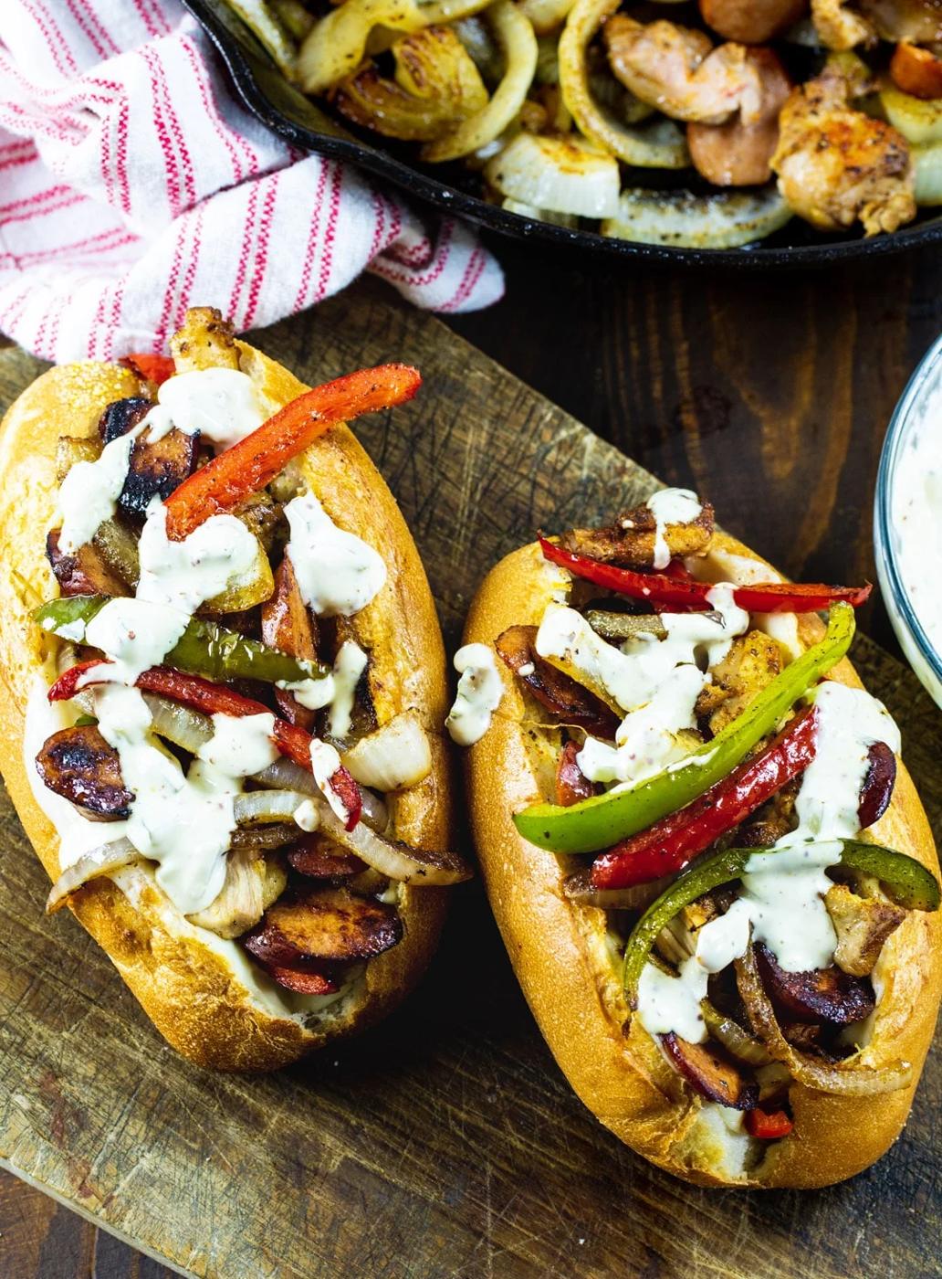 Two Chicken and Andouille Subs with skillet full of filling.