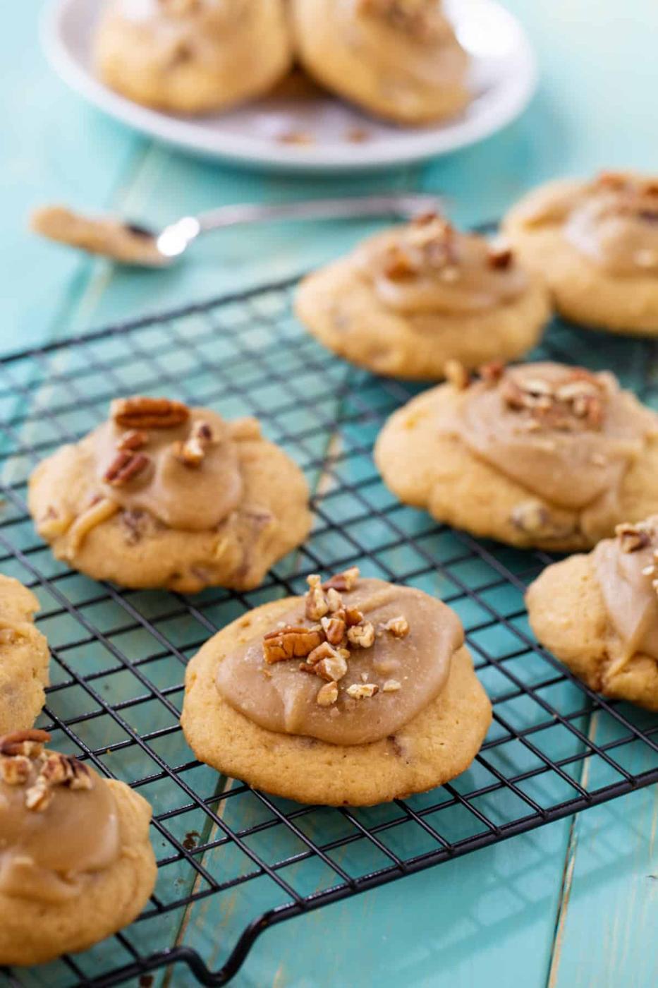 Frosted cookies on a wire rack.