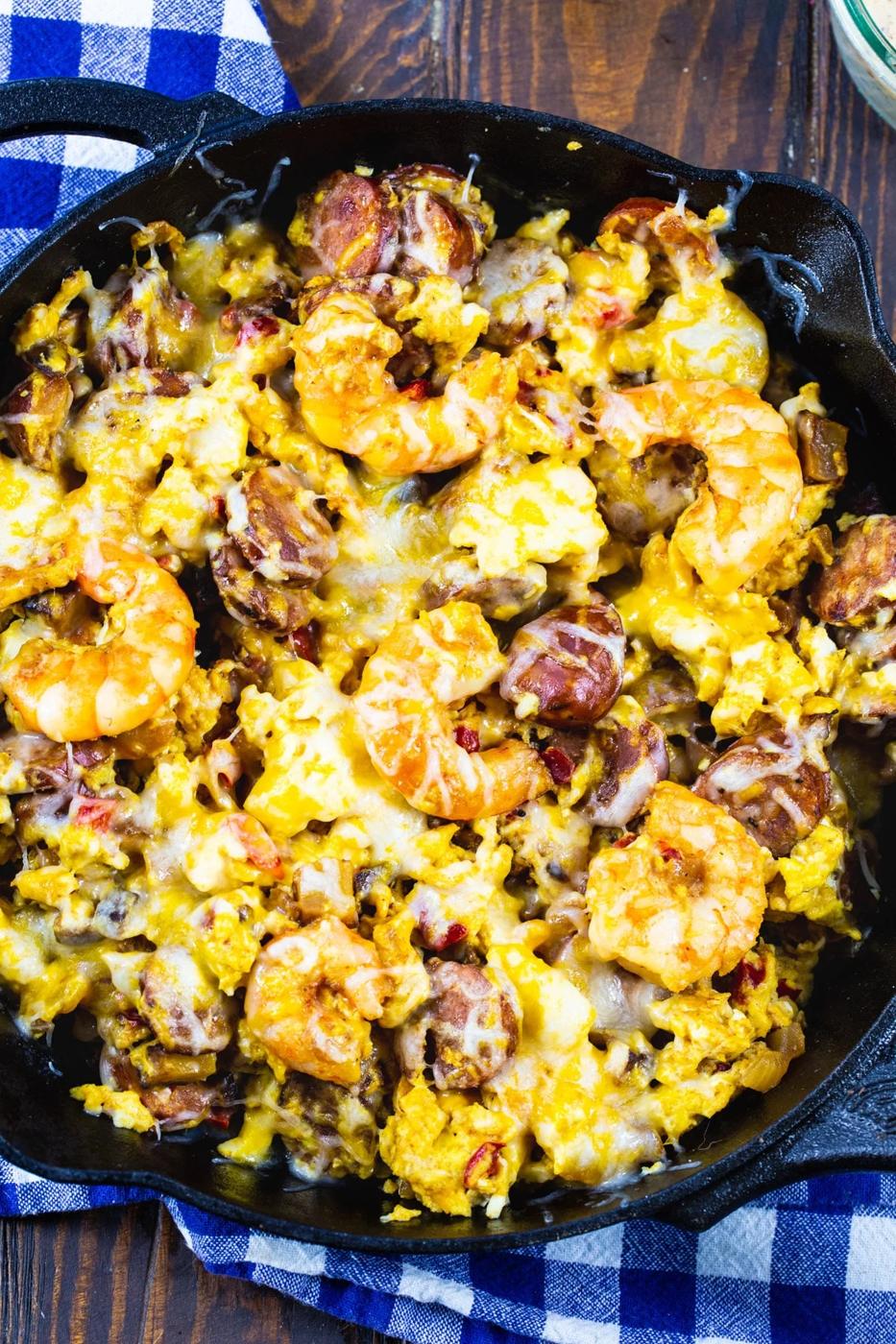 Breakfast Skillet with andouille and shrimp in a cast iron pan.