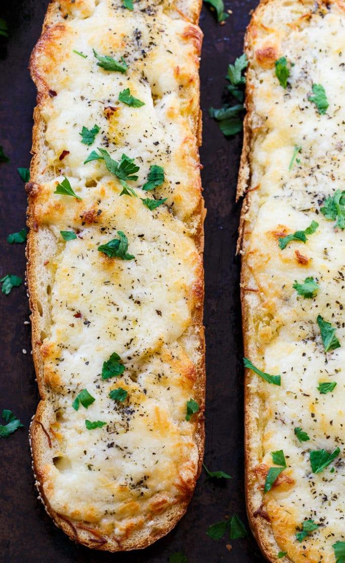 Cheesy Garlic Bread- lots of butter, mayo, garlic, and cheese make this bread insanely delicious!