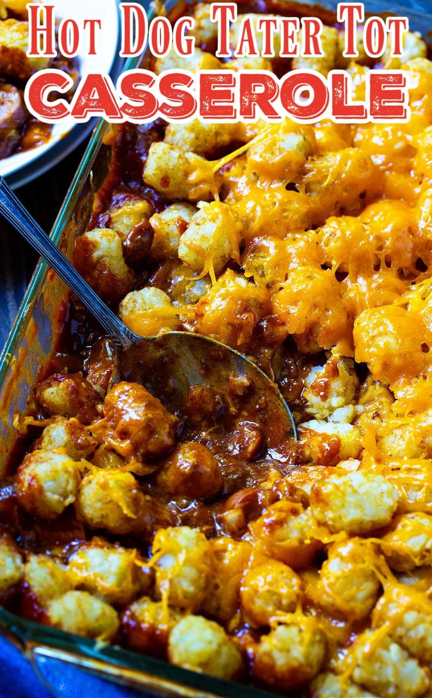 Spoon dishing up Cheesy Hot Dog Tater Tot Casserole.