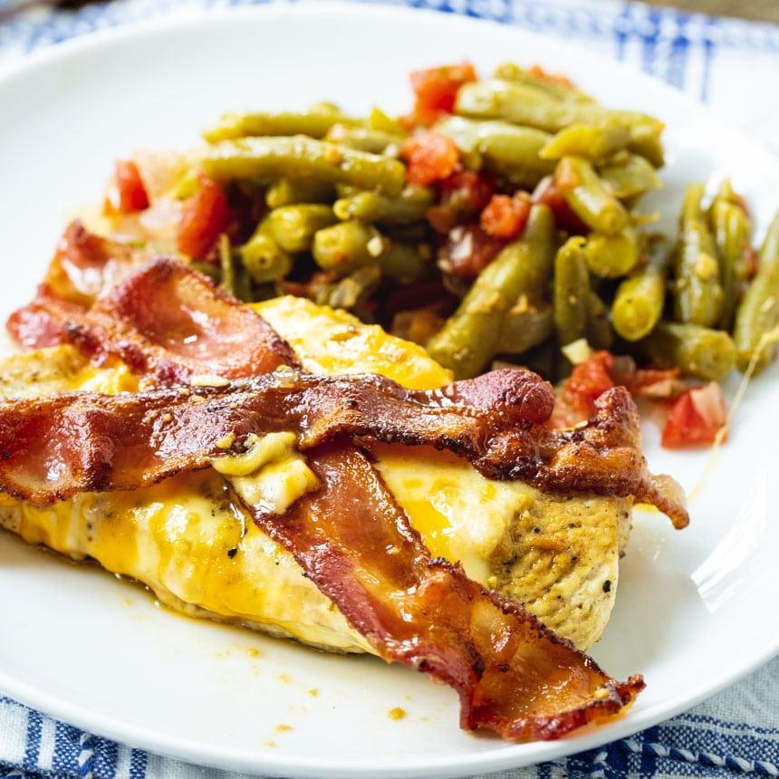 Chicken served on a plate with green beans.