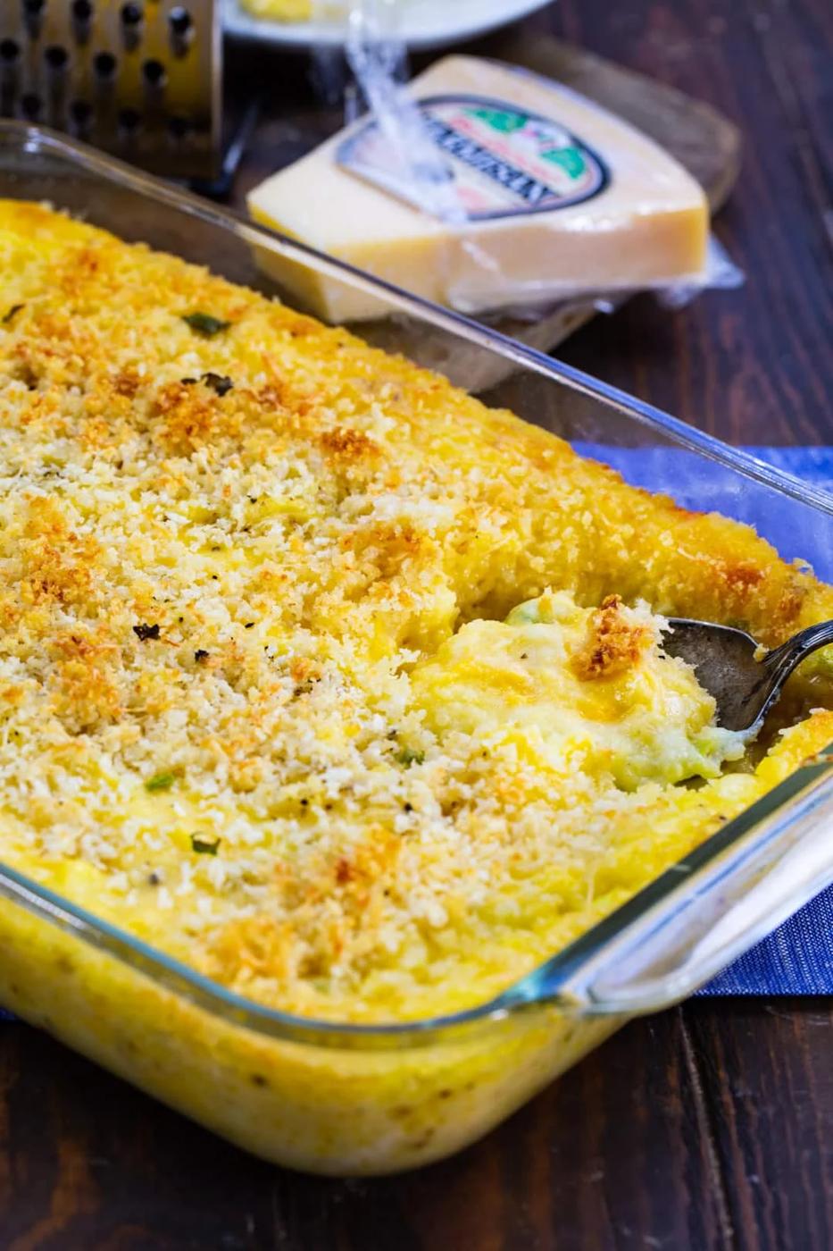 Spoon scooping casserole.