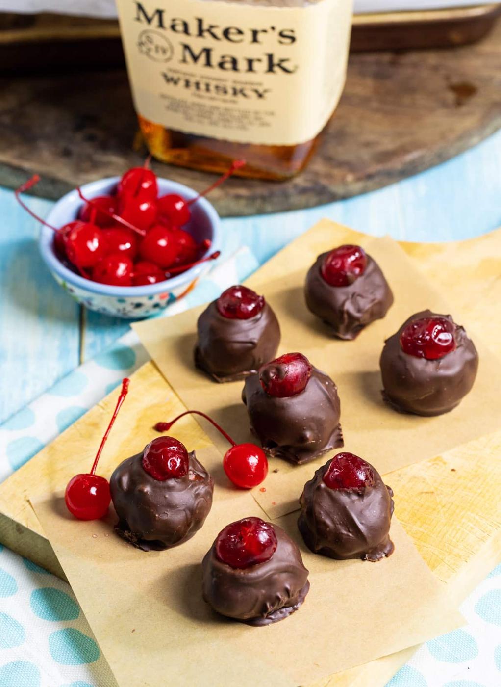Bourbon Balls, bowl full of cherries, and bottle of bourbon.