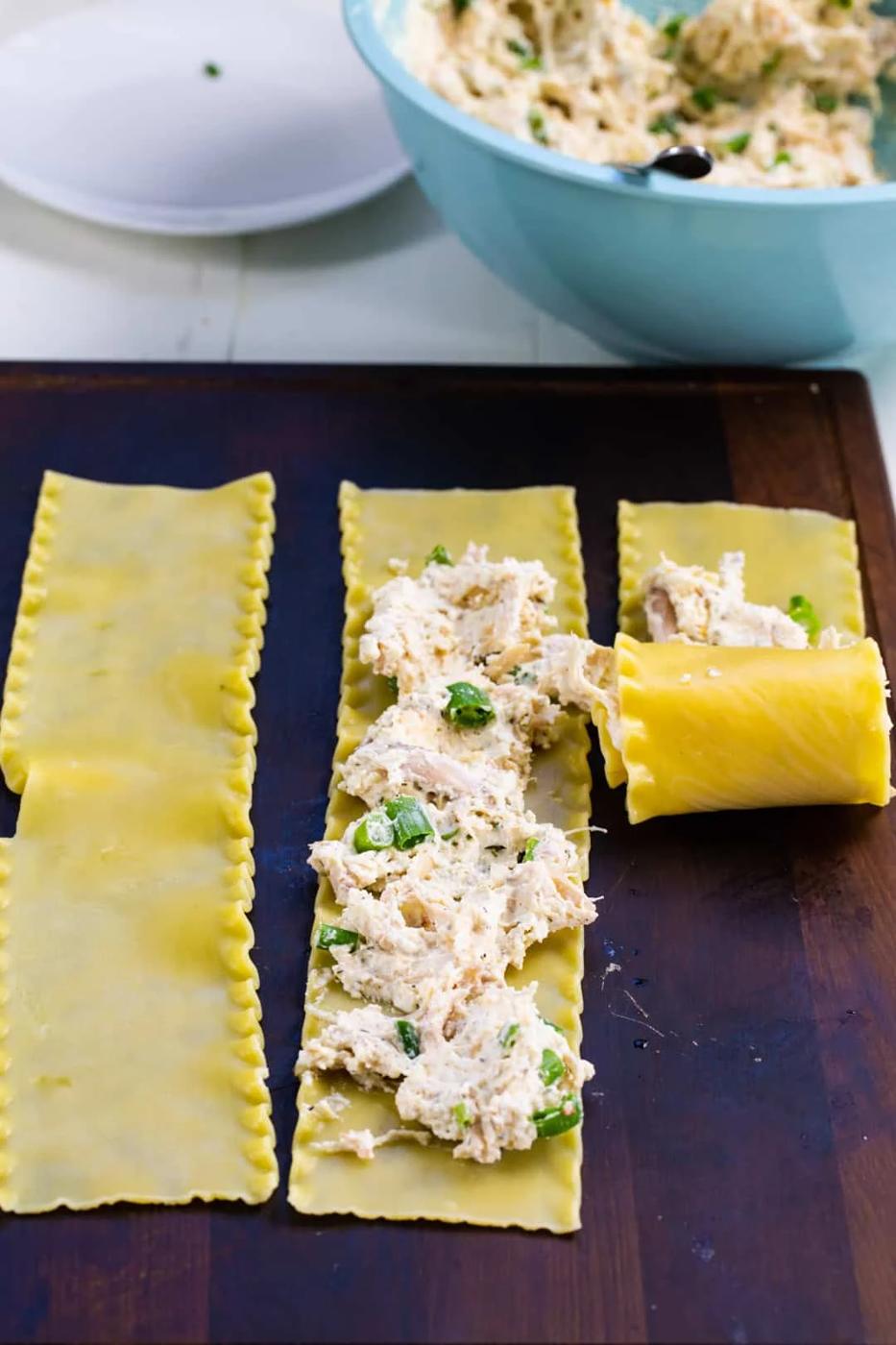 Filling spread on lasagna noodles.