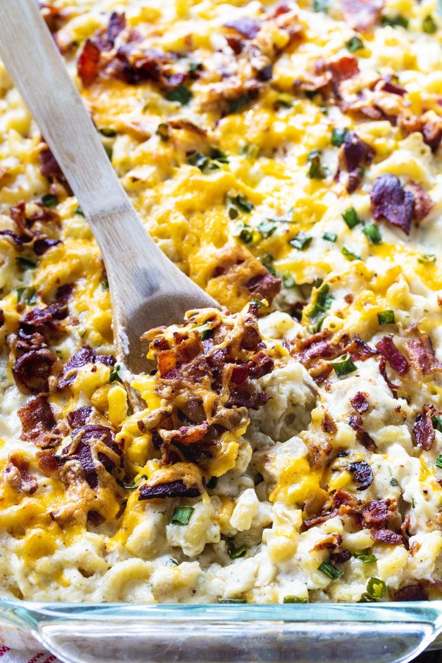 Wooden spoon scooping mac and cheese