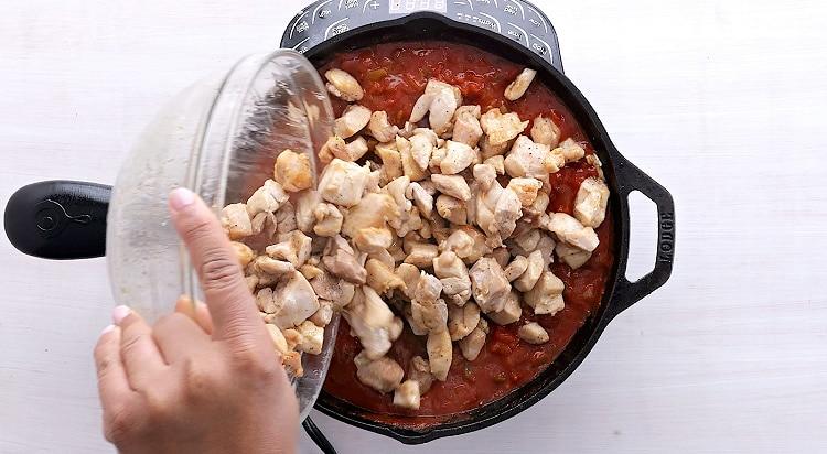 Returning chicken to skillet.
