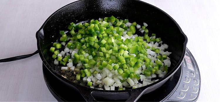 Cooking the onion, celery, and bell pepper.