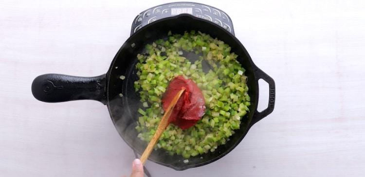 Adding tomato paste.