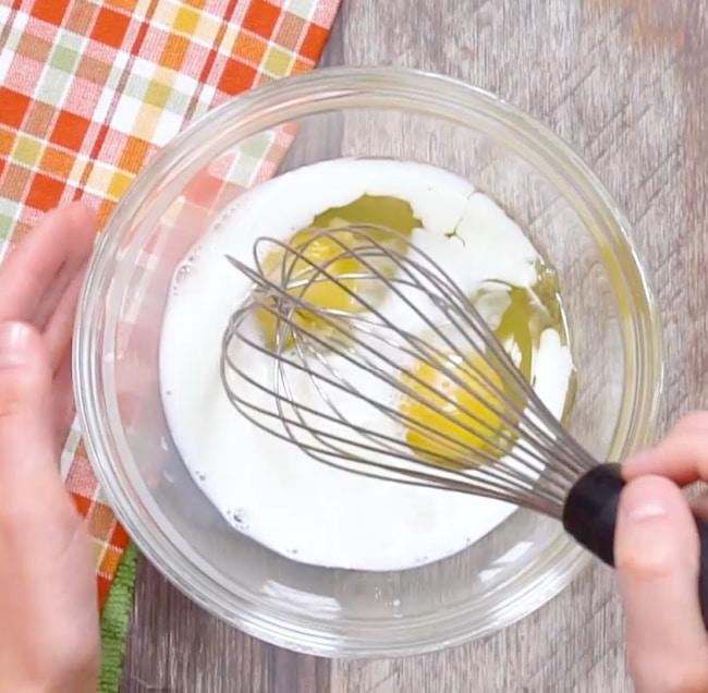 Mixing eggs and milk.