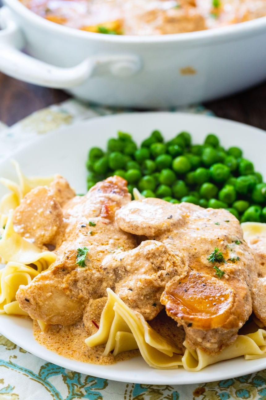 Chicken Paprikash served over egg noodles with peas.