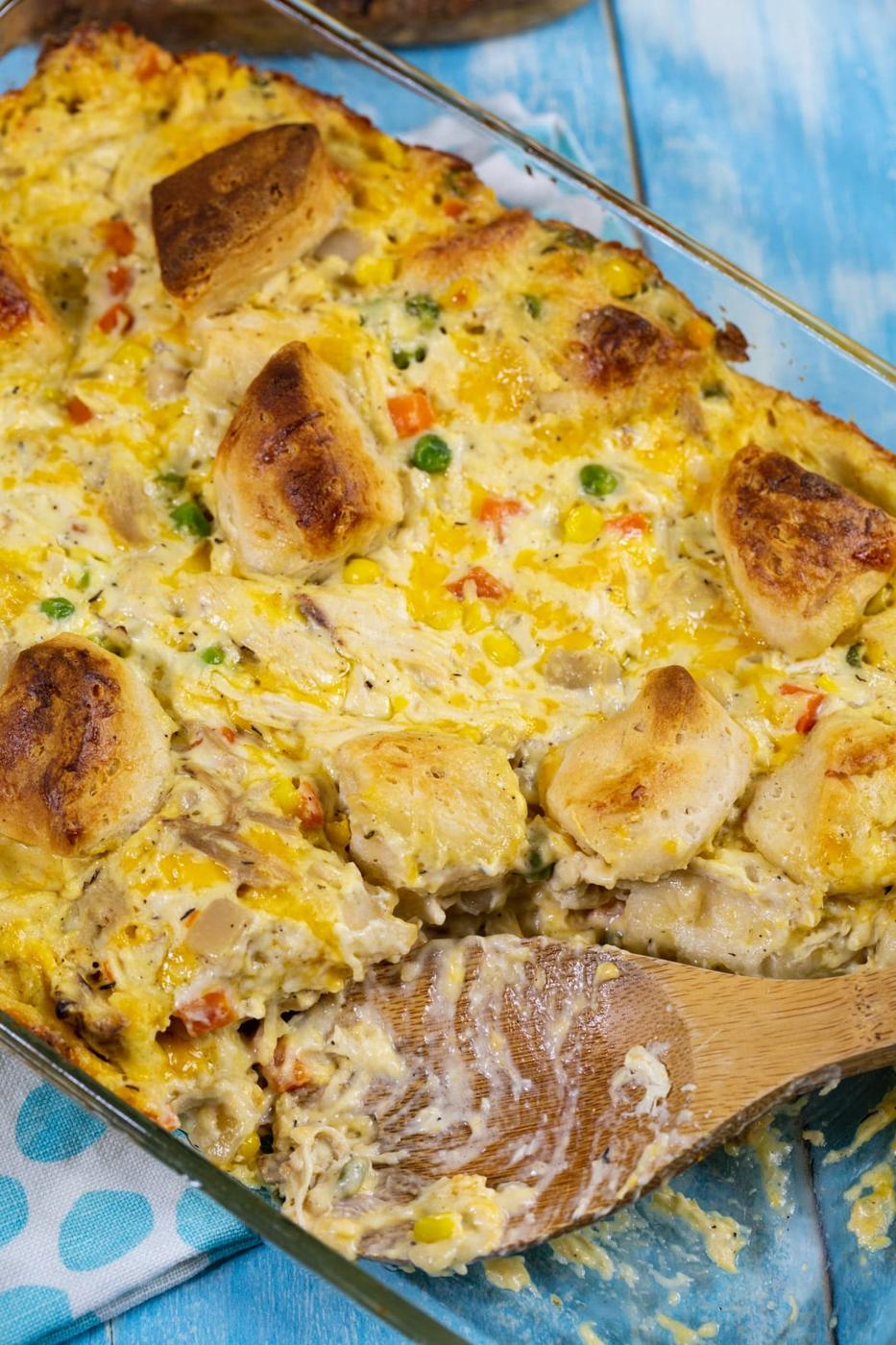 Wooden spoon scooping up casserole.