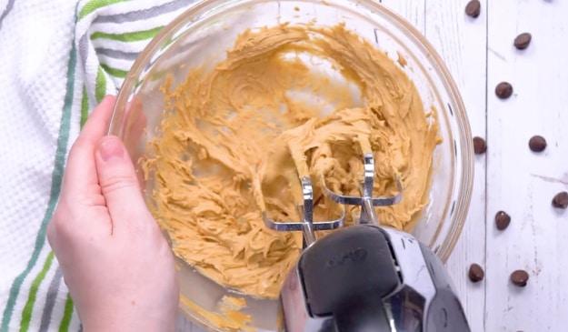 Mixing peanut butter mixture.