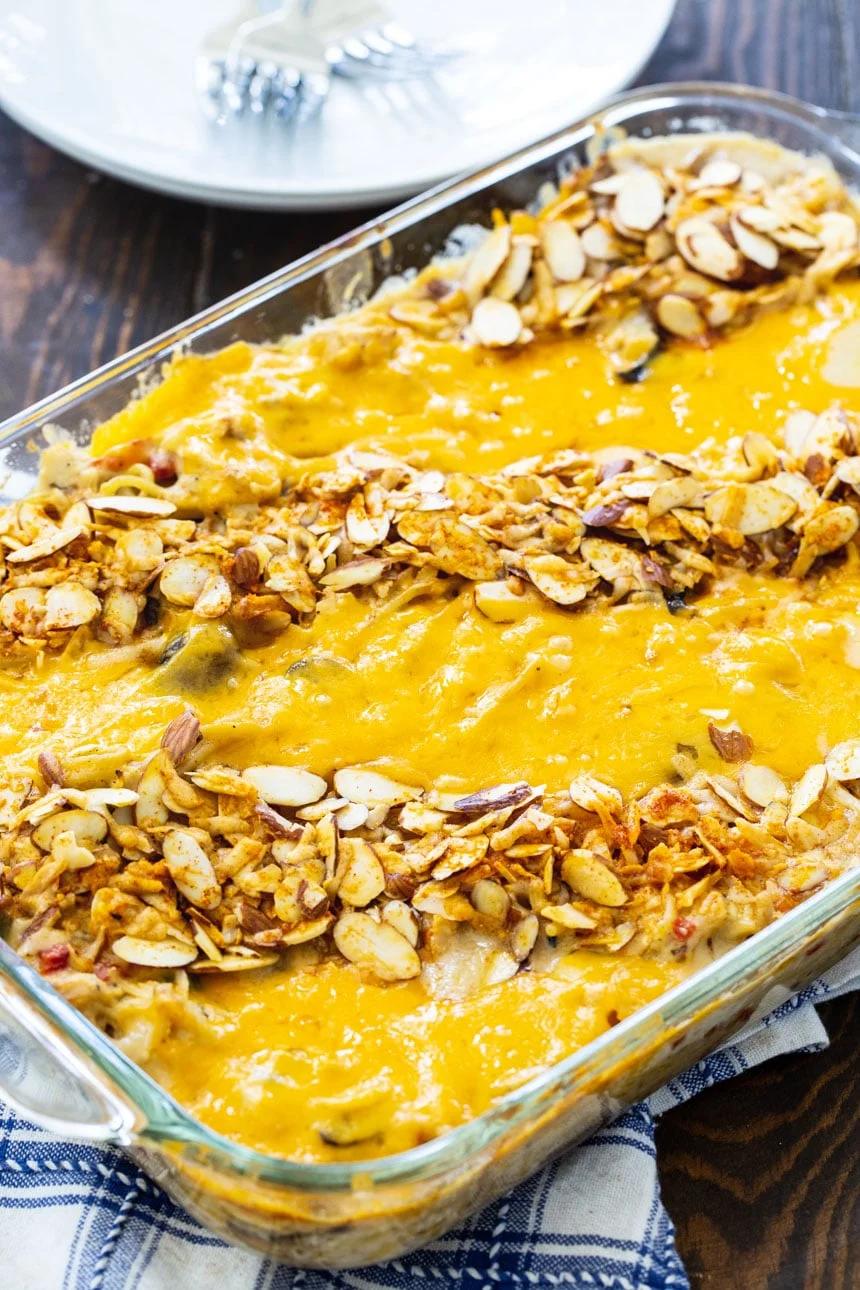 Chicken Tetrazzini topped with almonds and cheese in a 9x13-inch baking dish.