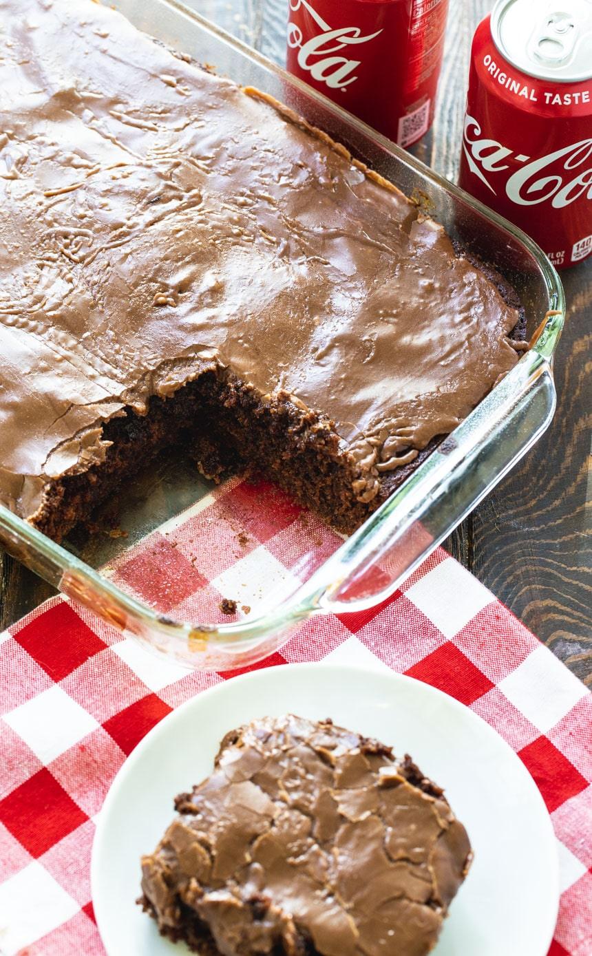 Cake in cake pan with a slice cut out.