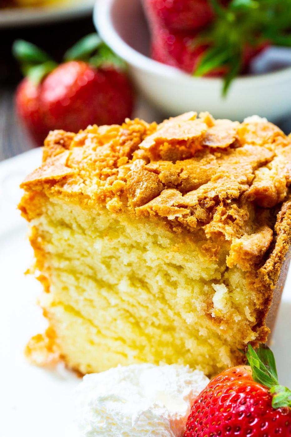 Slice of Classic Southern Pound Cake with fresh strawberries.