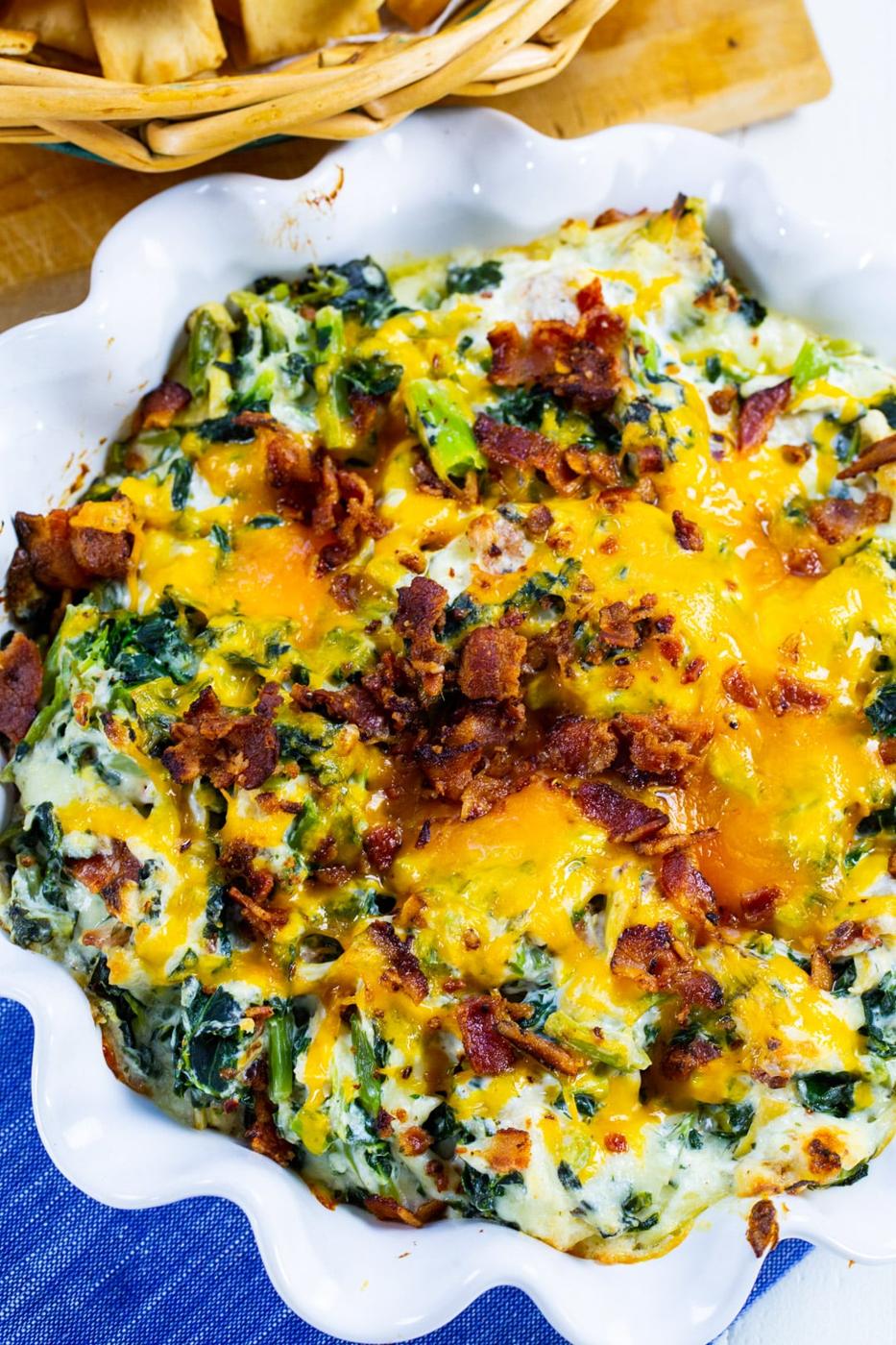 Artichoke Dip with Collards in round fluted baking dish.