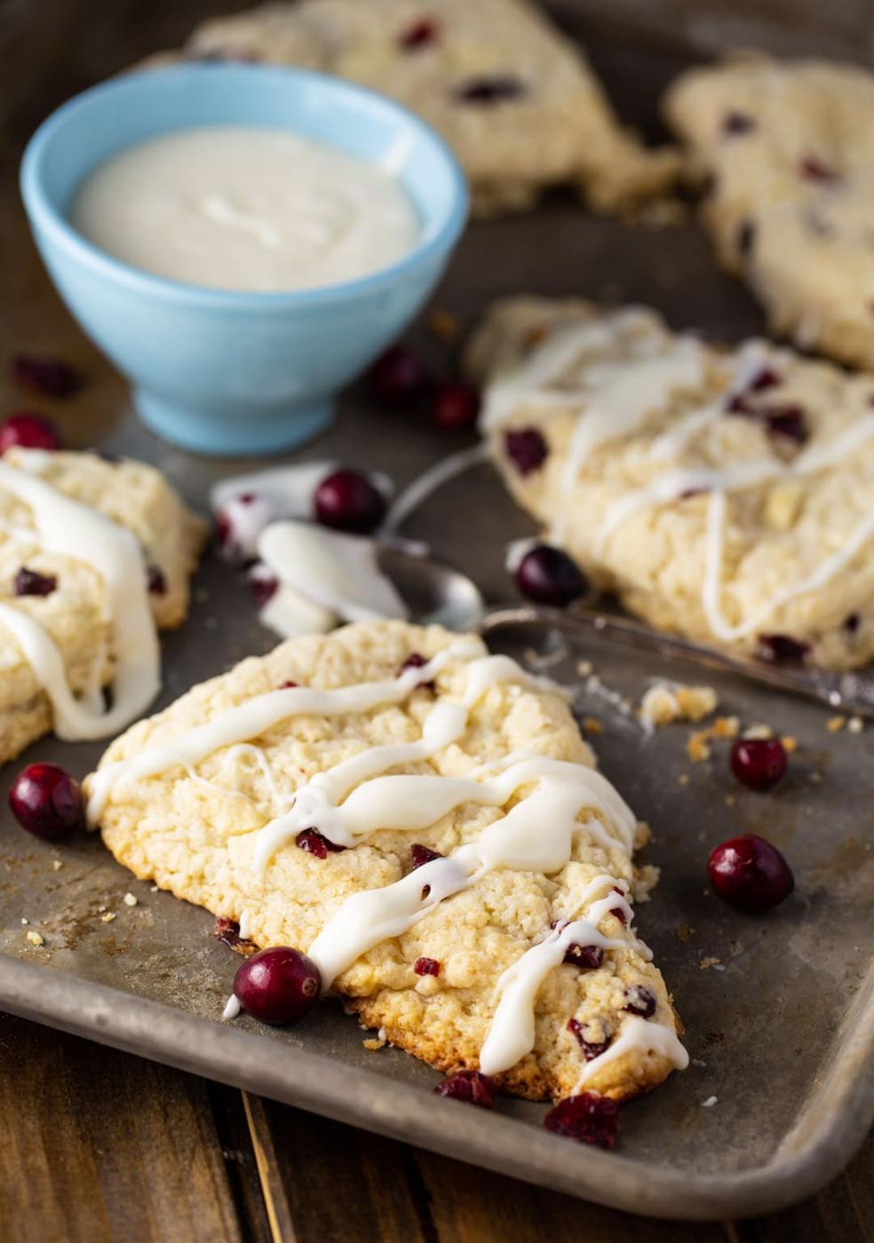 Scones on baking sheet and a bowl full of glaze.