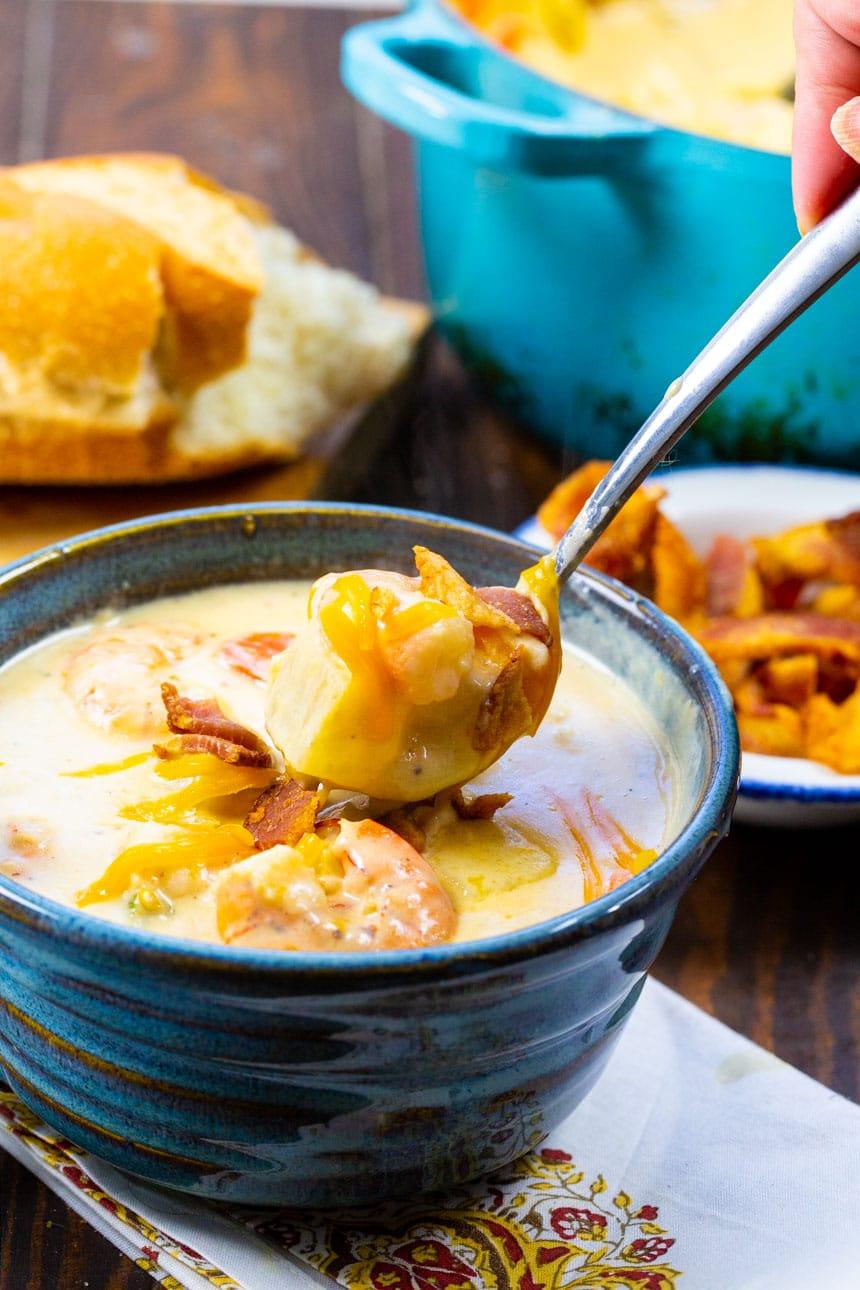 Spoon scooping Creamy Potato Soup with Shrimp.