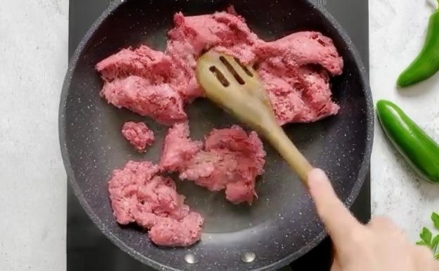 Browning ground beef in a skillet.