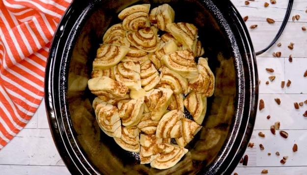 Cinnamon roll pieces in crockpot.