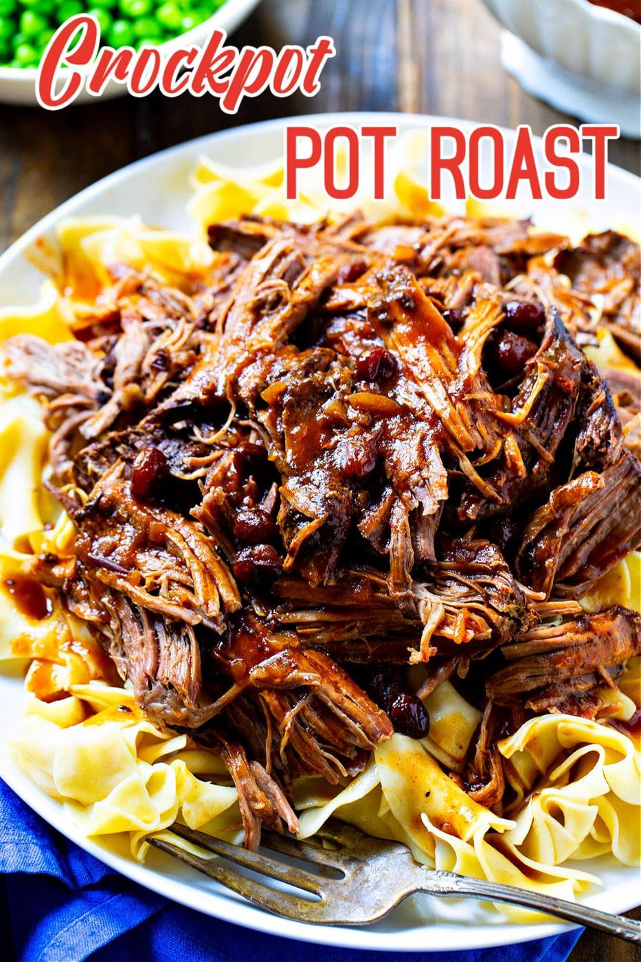 Crock Pot Pot Roast served over buttered noodles.