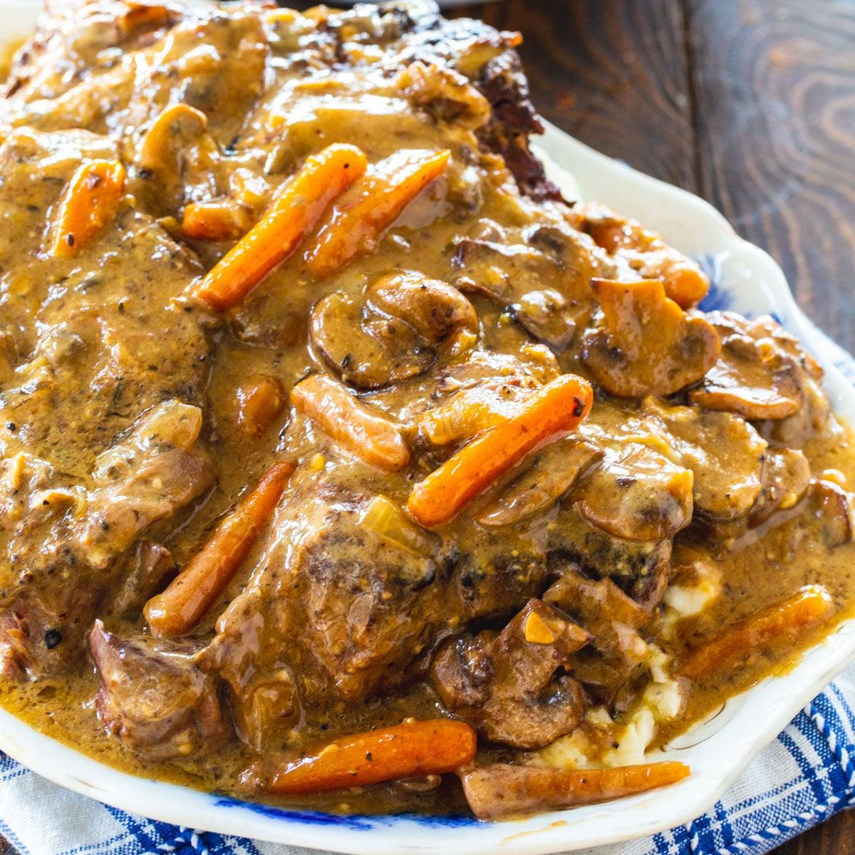 Crock Pot Roast with Mushroom Gravy on a serving platter.