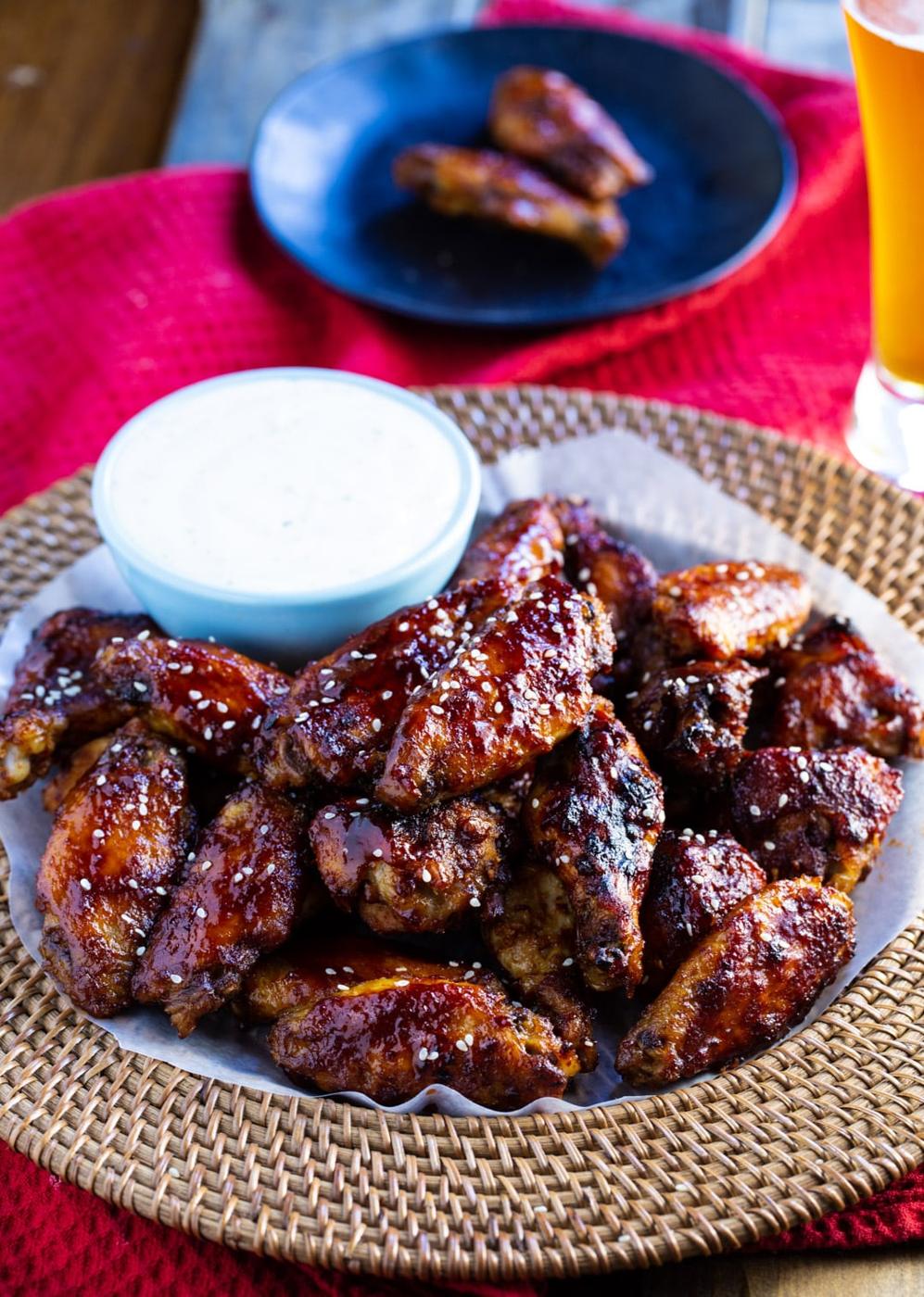 Wings on a serving tray with bowl of ranch dip.